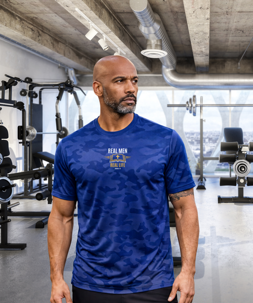 Man wearing RMRL Camo Dry-Fit Performance Tee in Deep Royal Blue camo with gold chest logo in a gym setting