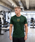 Focused man in modern gym wearing RMRL Emerald Green Camo Dry-Fit Tee with Real Men Real Life center-chest logo