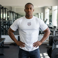 Man wearing RMRL Dry-Fit Performance Collection white tee with small chest logo standing in a gym